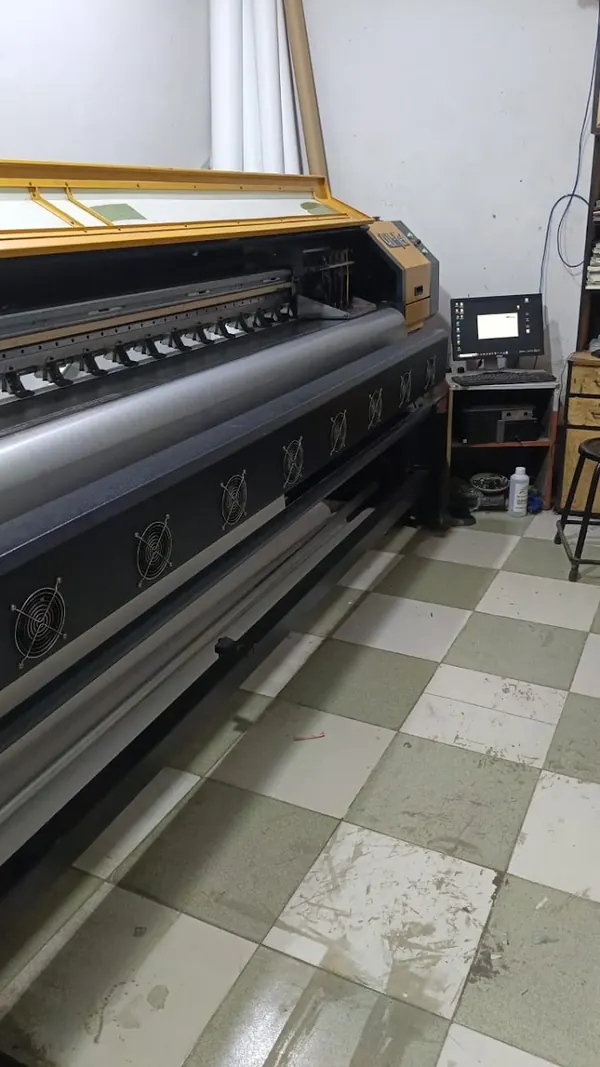 Large-format printer running a print in the shop